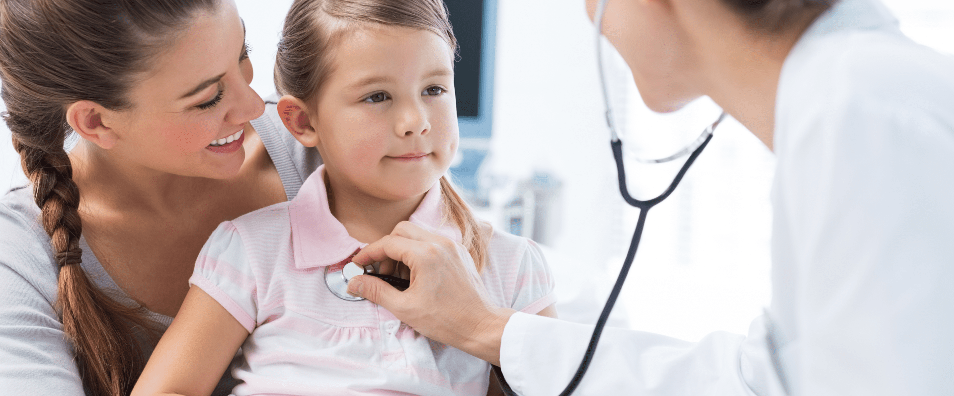 Pediatrician family doctor examining a young girl