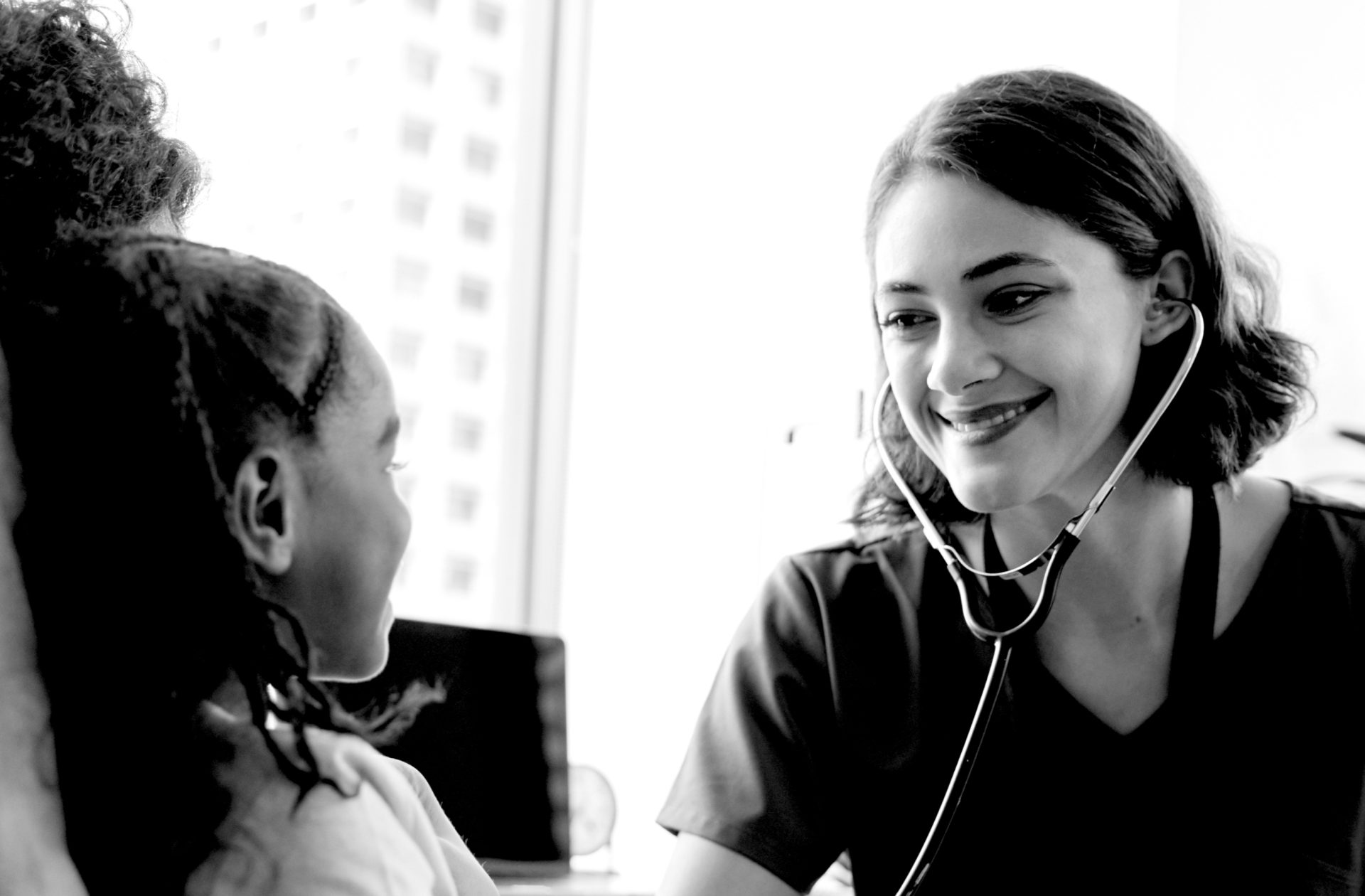 Family doctor examining a young girl